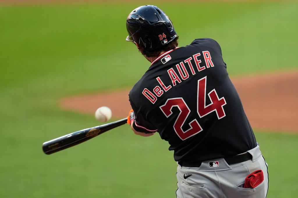 Cleveland Guardians' Chase DeLauter (24) hits a single in the first inning of a baseball game against the Cleveland Guardians, Sunday, April 12, 2026, in Atlanta. (AP Photo/Mike Stewart)