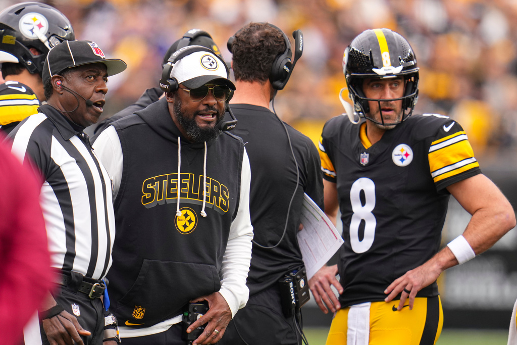 Pittsburgh Steelers head coach Mike Tomlin and quarterback Aaron Rodgers (8) talk with an official during a Indianapolis Colts challenge during the first half of an NFL football game in Pittsburgh, Sunday, Nov. 2, 2025. (AP Photo/Gene J. Puskar)