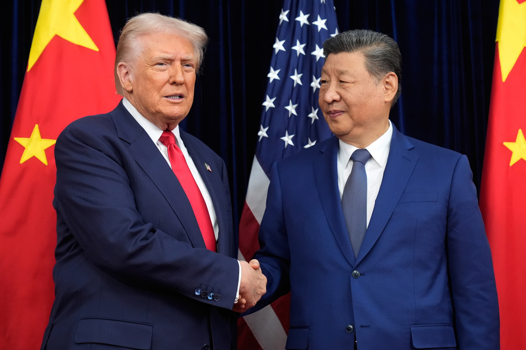 President Donald Trump, left, and Chinese President Xi Jinping shake hands before their meeting ahead of their summit talk at Gimhae International Airport in Busan, South Korea, Thursday, Oct. 30, 2025. (AP Photo/Mark Schiefelbein)