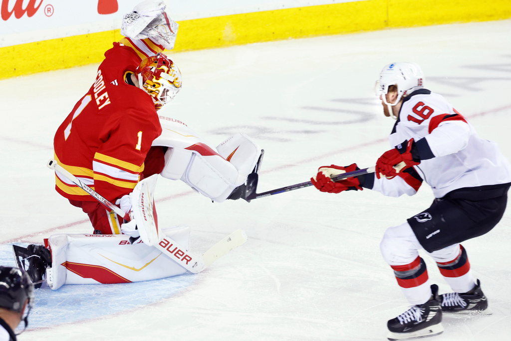New Jersey Devils' Connor Brown, right, has a breakaway shot stopped by Calgary Flames goalie Devin Cooley (1) during second-period NHL hockey game action in Calgary, Alberta, Monday, Jan. 19, 2026. (Larry MacDougal/The Canadian Press via AP)