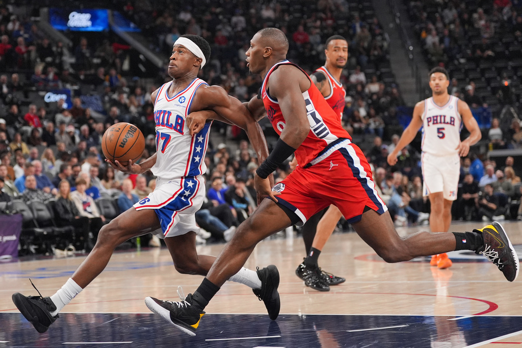 Los Angeles Clippers guard Kris Dunn (8) pressures Philadelphia 76ers guard Vj Edgecombe (77) during the first half of an NBA basketball game Monday, Feb. 2, 2026, in Inglewood, Calif. (AP Photo/Jae C. Hong)