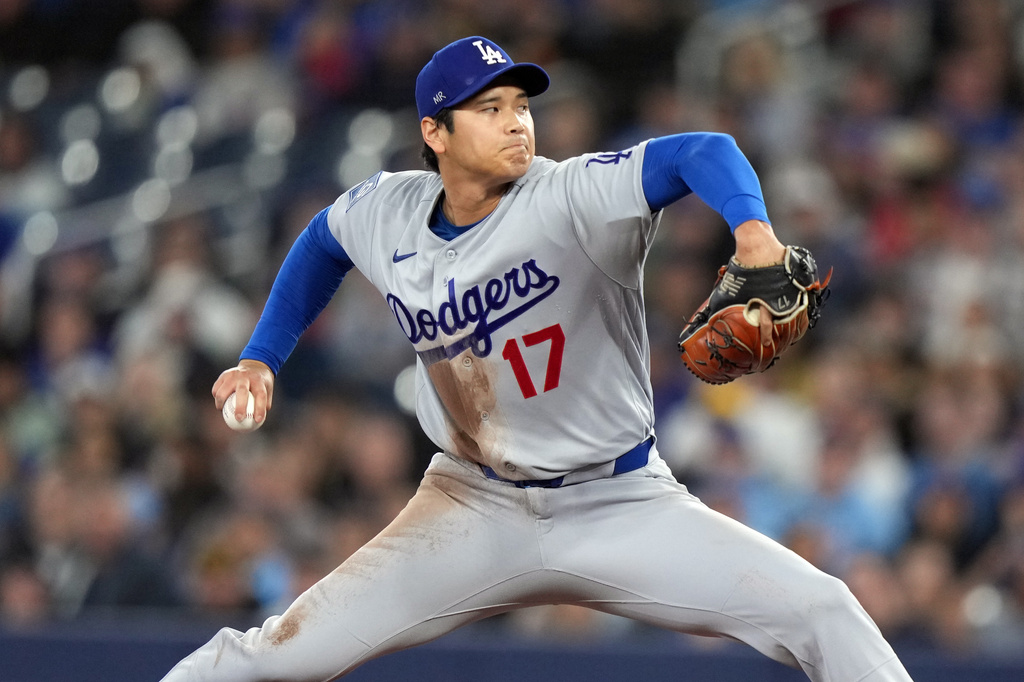 Los Angeles Dodgers pitcher Shohei Ohtani (17) throws during first inning of a baseball against the Toronto Blue Jays in Toronto, Wednesday, April 8, 2026. (Nathan Denette/The Canadian Press via AP)