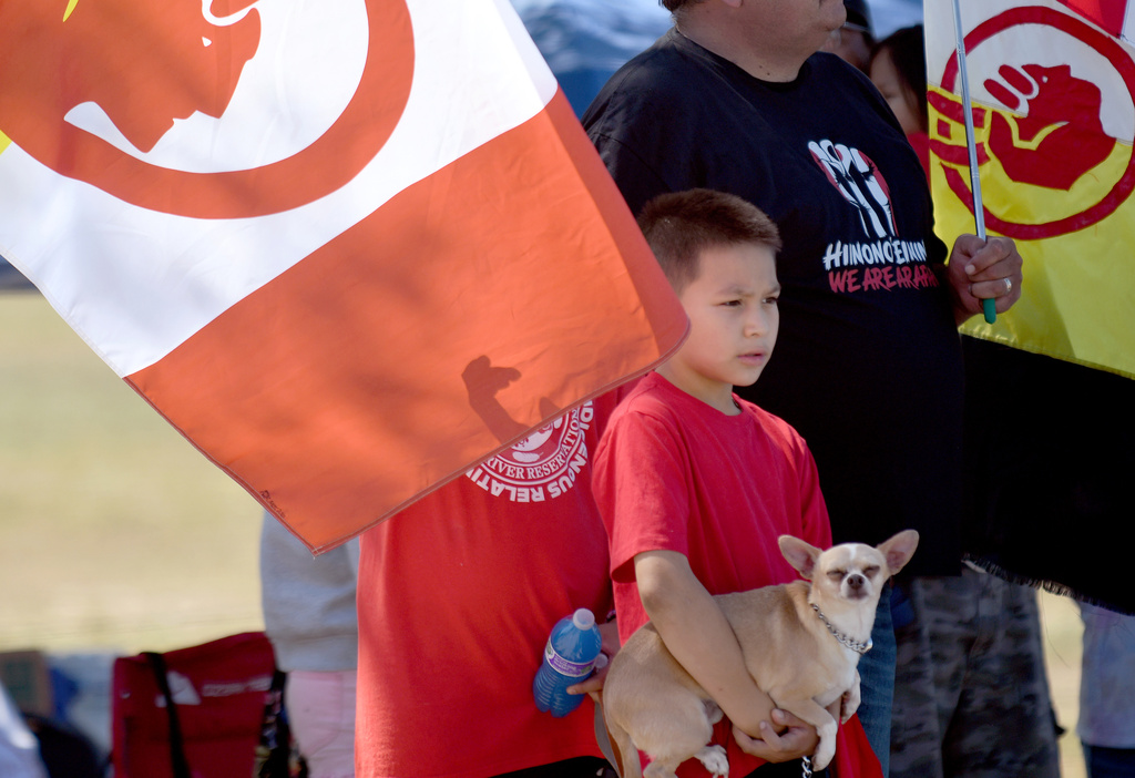 Raphael C'Hair stands amid protesters near the Foundations for Nations church in Arapahoe, Wyo., on Sunday, Aug. 16, 2026. (AP Photo/Thomas Peipert)