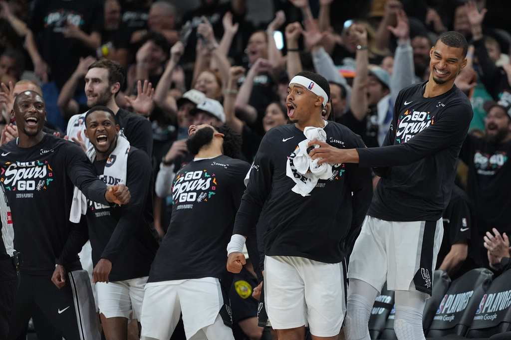 San Antonio Spurs forward Victor Wembanyama, right, and forward Keldon Johnson, second from right, reacts to a play with teammates during the second half in Game 2 of a second-round NBA playoffs basketball series against the Minnesota Timberwolves in San Antonio, Wednesday, May 6, 2026. (AP Photo/Eric Gay)
