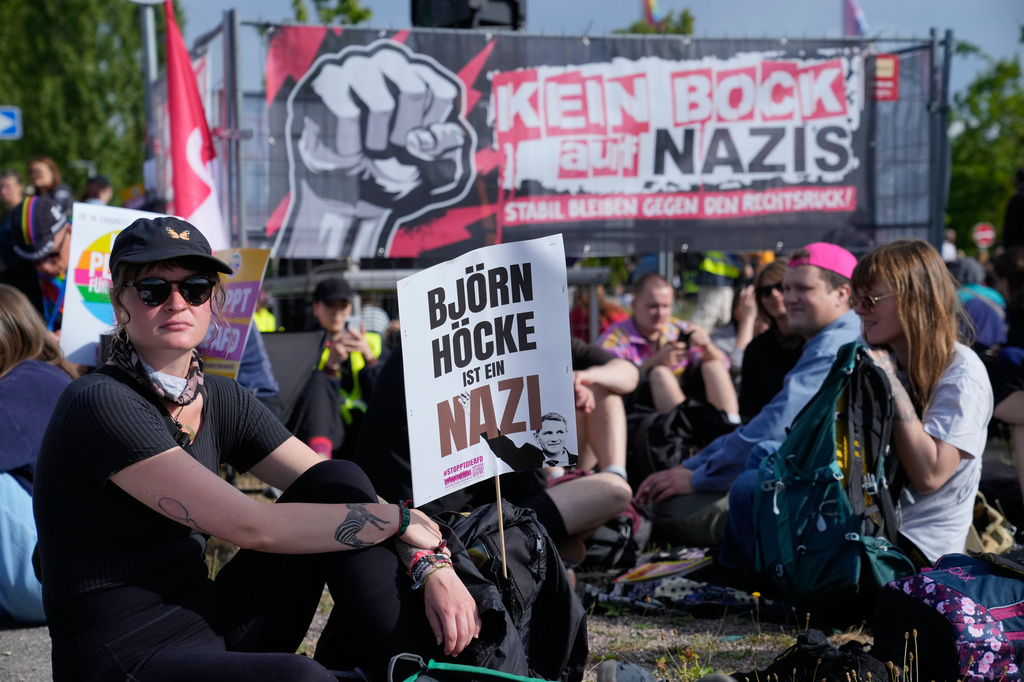 A protester with a poster reads: "Bjoern Hoecke is a Nazi" attend a rally against a party convention of Alternative for Germany, or AfD in Erfurt, Germany, Saturday, July 4, 2026. (AP Photo/Ebrahim Noroozi)