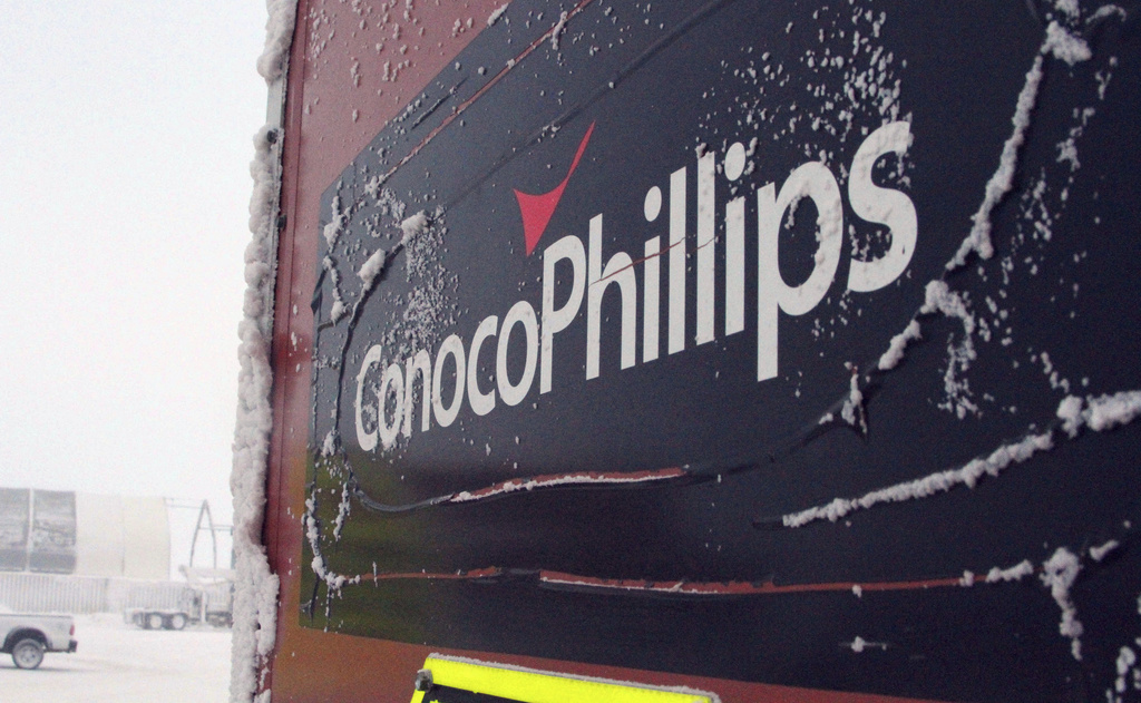 FILE - An ice-covered ConocoPhillips sign is displayed at the Colville-Delta 5, more commonly known as CD5, drilling site on Alaska's North Slope, Feb. 9, 2016. (AP Photo/Mark Thiessen, File)