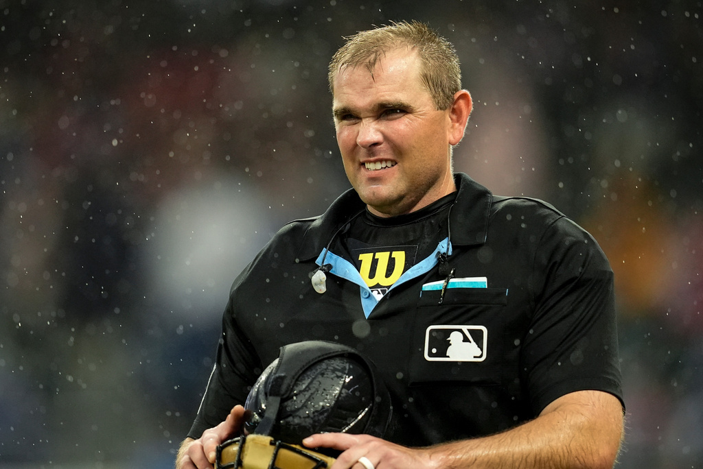 An MLB umpire leaves the game due to rain in the sixth inning of a baseball game between the Atlanta Braves and the Washington Nationals, Sunday, May 24, 2026, in Atlanta. (AP Photo/Mike Stewart)