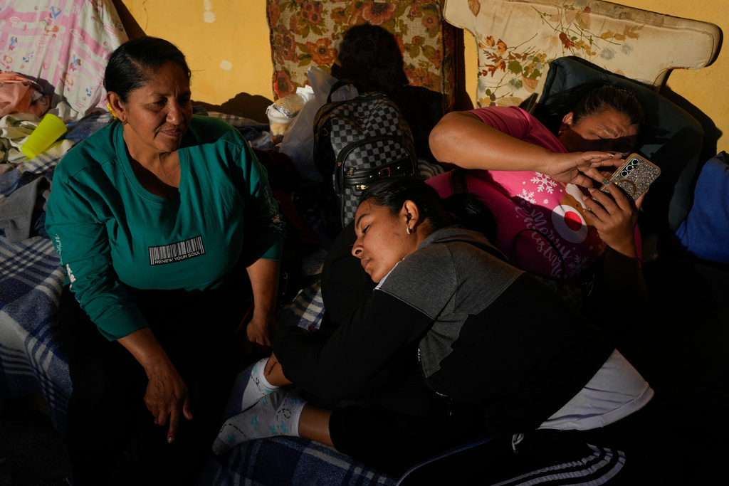 Mileidy Mendoza, center, waits at Zone 7 of the Bolivarian National Police, where her fiancé Eric Diaz is being held as a political detainee in Caracas, Venezuela, Sunday, Jan. 11, 2026, after the government announced prisoners would be released.(AP Photo/Matias Delacroix)