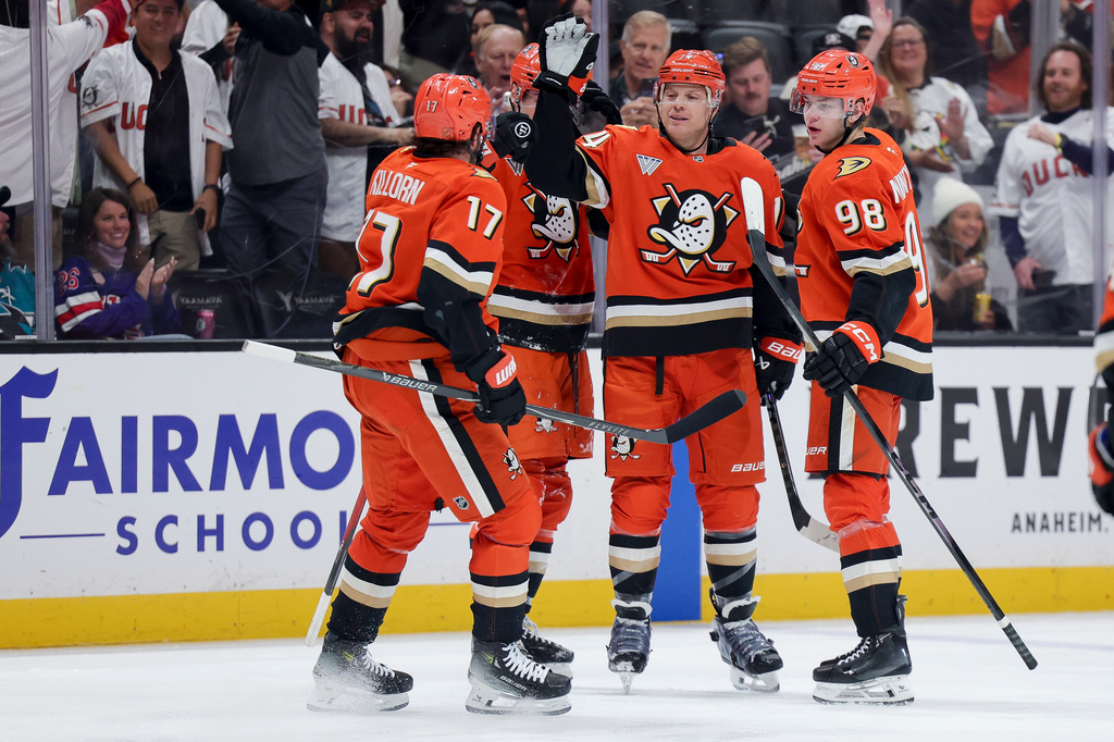 Anaheim Ducks defenseman John Carlson, second from right, celebrates with left wing Alex Killorn (17), right wing Beckett Sennecke, second from left, and defenseman Pavel Mintyukov (98)t, after scoring during the first period of an NHL hockey game against the San Jose Sharks, Thursday, April 9, 2026, in Anaheim, Calif. (AP Photo/Ryan Sun)
