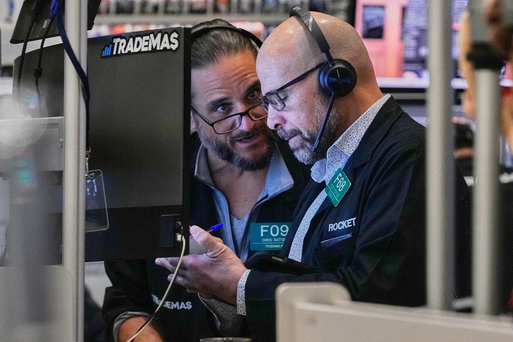Options traders Chris Dattolo, left, and Steven Rodriguez work on the floor of the New York Stock Exchange, Friday, Feb. 20, 2026. (AP Photo/Richard Drew)