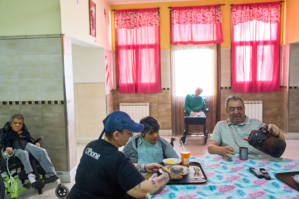 Residents gather in a communal space at the Pequeño Cottolengo Don Orione, a home for people with disabilities that will be visited by Pope Leo XIV in November, in Buenos Aires, Argentina, Thursday, Sept. 24, 2026. (AP Photo/Rodrigo Abd)