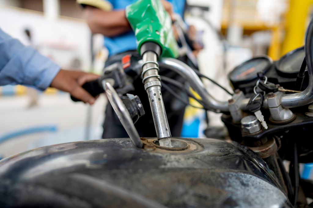 FILE - A man fills petrol in a two wheeler at a fuel pump in Prayagraj, in the northern Indian state of Uttar Pradesh, May 5, 2025. (AP Photo/Rajesh Kumar Singh, File)