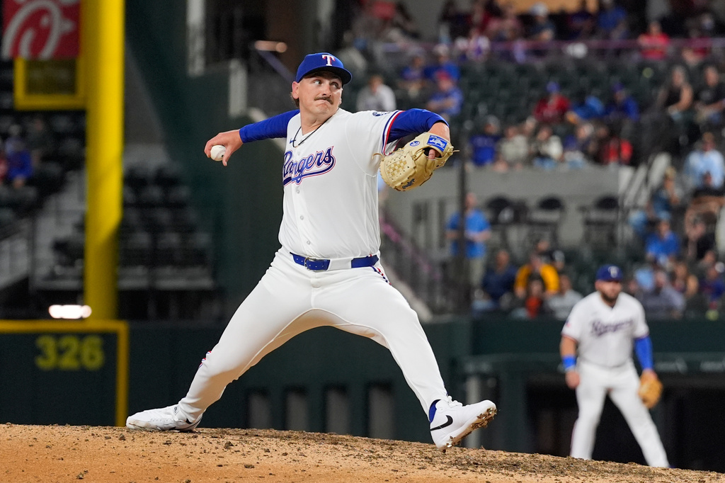 Texas Rangers relief pitcher Peyton Gray throws to the Pittsburgh Pirates in the ninth inning of a baseball game Thursday, April 23, 2026, in Arlington, Texas. (AP Photo/Tony Gutierrez)