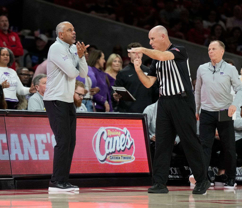 Kansas State head coach Jerome Tang, left, reacts as he was issued his second technical by referee Michael Greenstein, second from right, during the second half of an NCAA college basketball game, Saturday, Feb. 14, 2026, in Houston. (AP Photo/ Karen Warren)