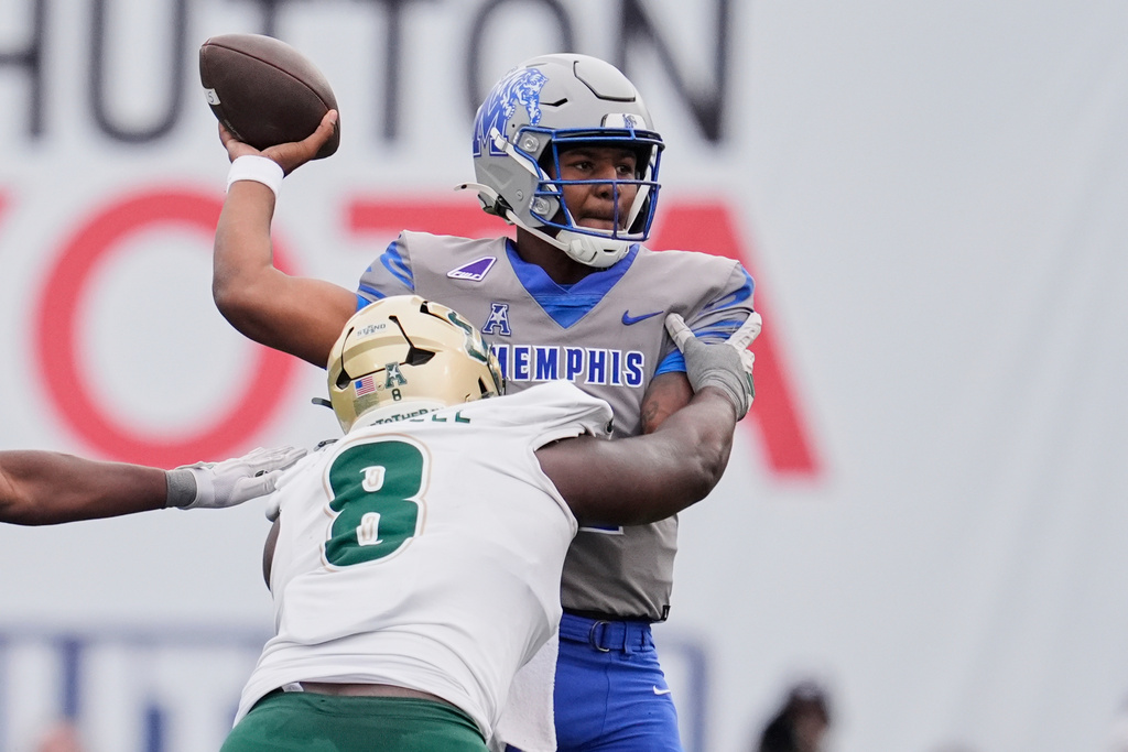 South Florida defensive lineman Traevon Mitchell (8) pressures Memphis quarterback Brendon Lewis (2) as he throws a pass during the first half of an NCAA college football game Saturday, Oct. 25, 2025, in Memphis, Tenn. (AP Photo/George Walker IV)