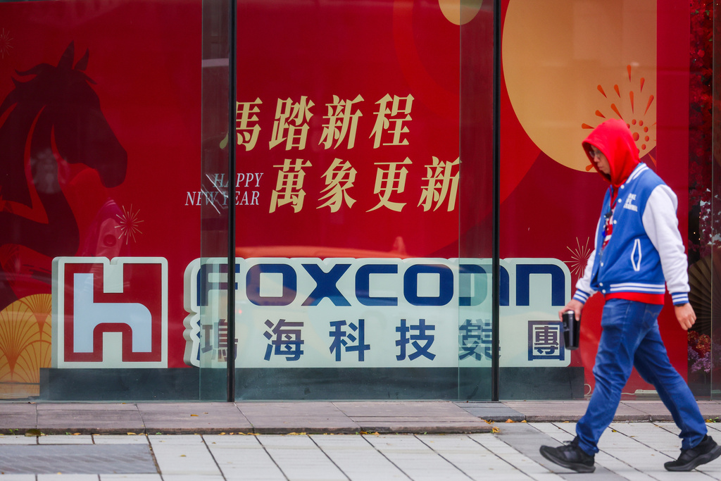 A man walks past the entrance to a Foxconn or Hon Hai company complex in Taipei, Taiwan, on Tuesday, Jan. 27, 2026. (AP Photo/Daniel Ceng)