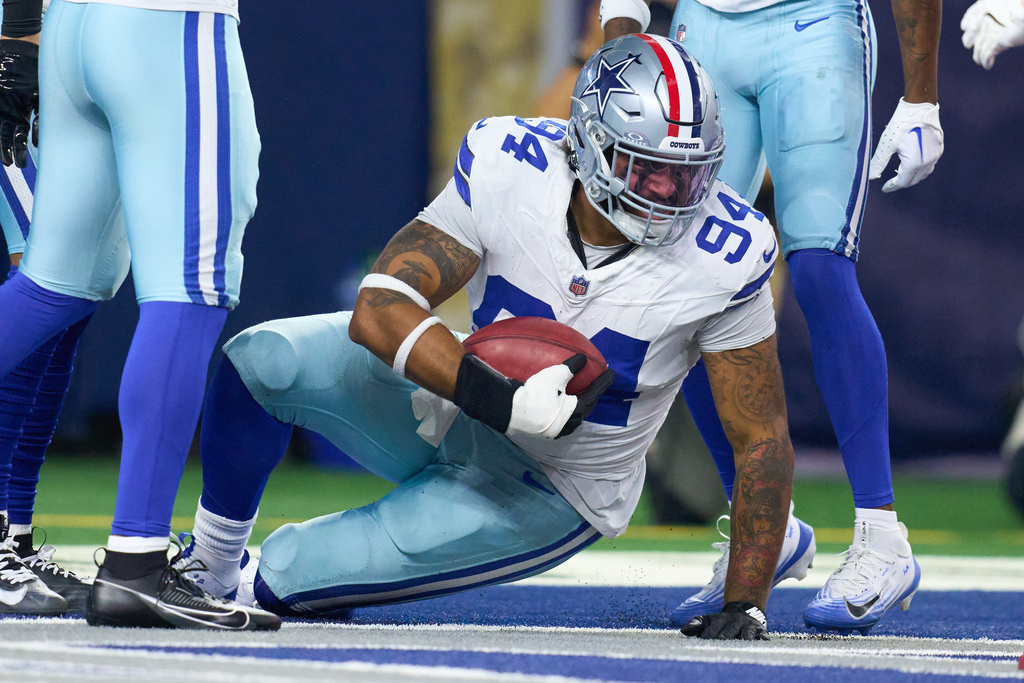 Dallas Cowboys defensive end Marshawn Kneeland (94) holds the football after recovering an Arizona Cardinals blocked bunt for a touchdown during an NFL football game between the Dallas Cowboys and the Arizona Cardinals Monday, Nov. 3, 2025, in Arlington, Texas. (AP Photo/Julio Cortez)