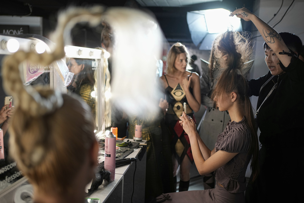 Models are prepared for a runway show at the backstage of the Moscow Fashion Week in Moscow, Russia, Friday, Aug. 29, 2025. (AP Photo/Pavel Bednyakov)