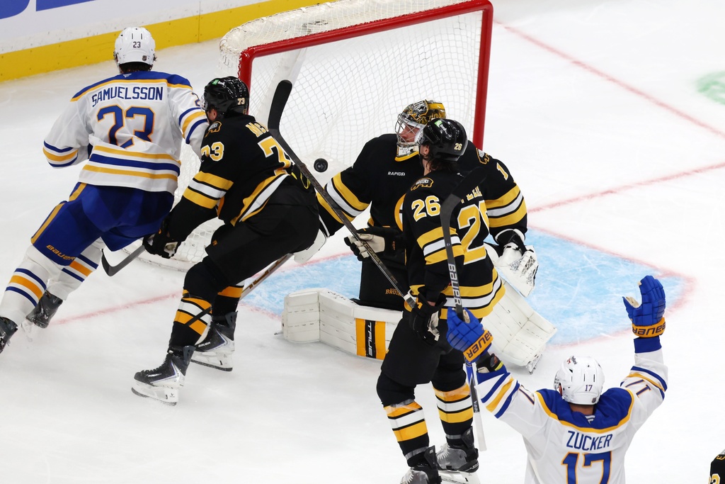 Buffalo Sabres' Jason Zucker (17) celebrates after his goal against Boston Bruins' Jeremy Swayman (1) as Bruins' Andrew Peeke (26) and Charlie McAvoy (73) skate away with Sabres' Mattias Samuelsson (23) during the third period of an NHL hockey game, Saturday, Oct. 11, 2025, in Boston. (AP Photo/Michael Dwyer)