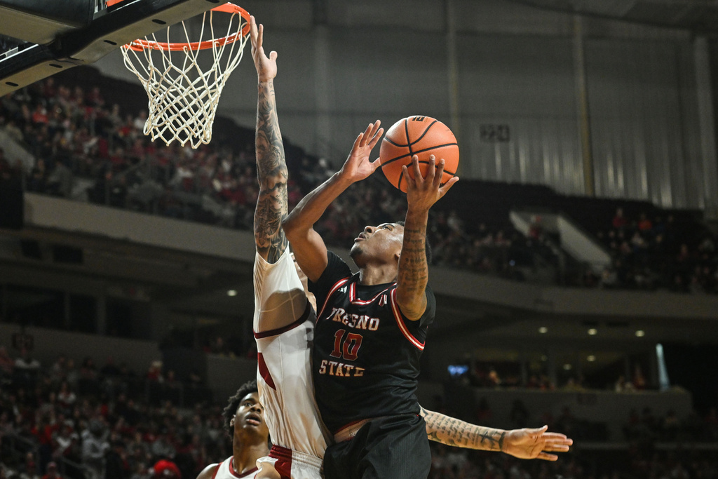 Fresno State guard Zaon Collins (10) shoots over Arkansas forward Trevon Brazile (7) during the first half of an NCAA college basketball game Saturday, Dec. 6, 2025, in North Little Rock, Ark. (AP Photo/Michael Woods)