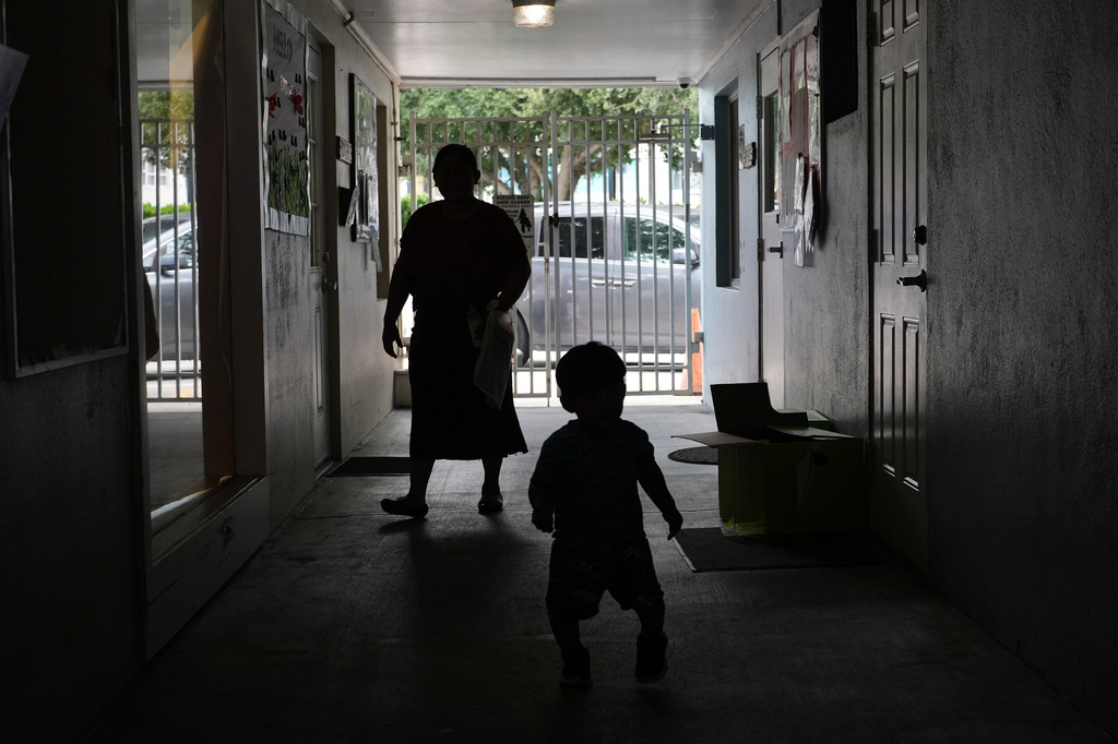 A parent walks with her child at a Head Start preschool in Immokalee, Fla., Thursday, Sept. 10, 2026. (AP Photo/Rebecca Blackwell)