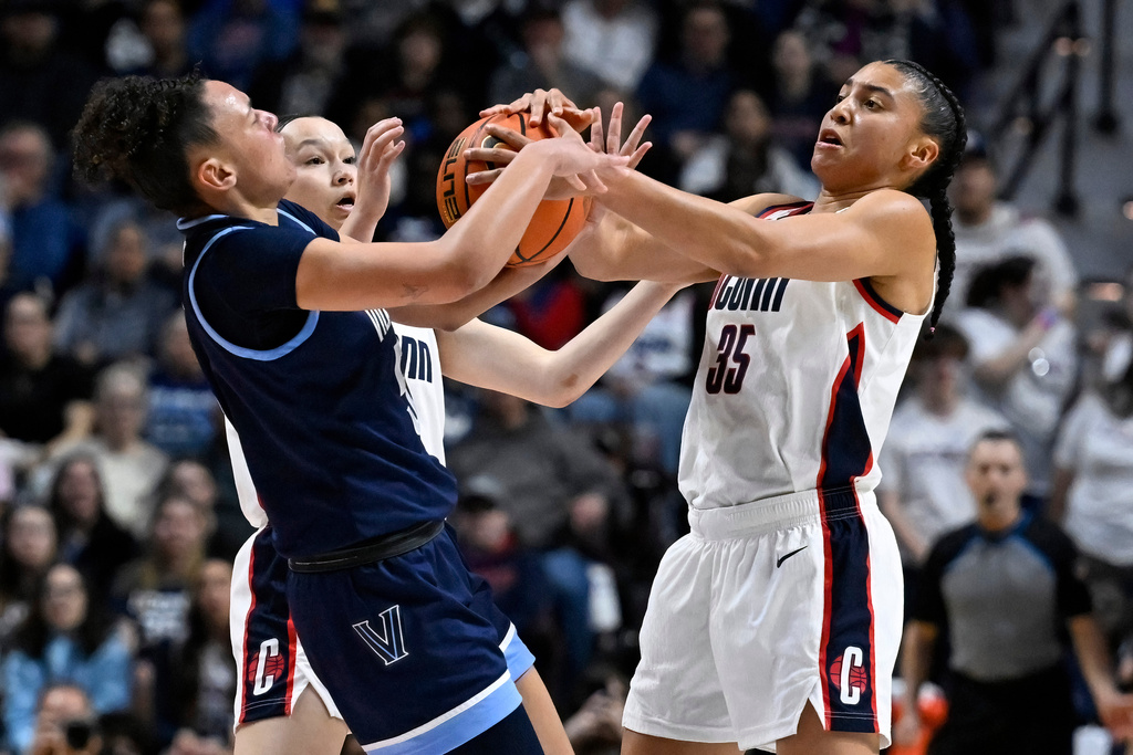 UConn guards Kayleigh Heckel, back left, and Azzi Fudd, right, pressures Villanova guard Ryanne Allen during first half of an NCAA college basketball game in the finals of the Big East tournament, Monday, March 9, 2026, in Uncasville, Conn. (AP Photo/Jessica Hill)