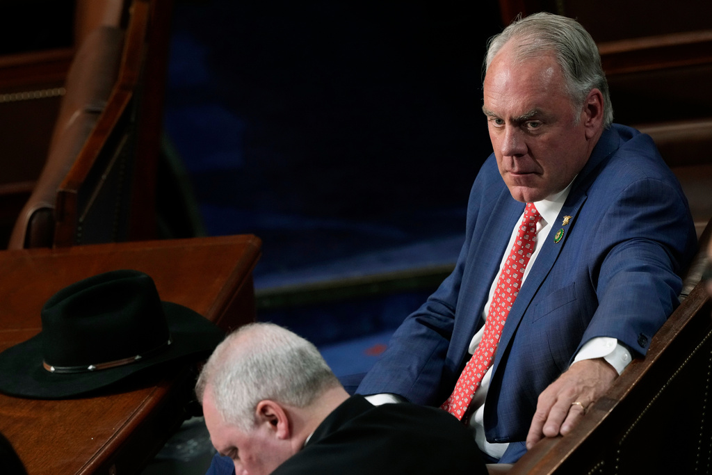 FILE - Rep.-elect Ryan Zinke, R-Mont., looks to Rep. Steve Scalise, R-La., in the House chamber as the House meets for the third day to elect a speaker and convene the 118th Congress, Jan. 5, 2023, in Washington. (AP Photo/Andrew Harnik, File)