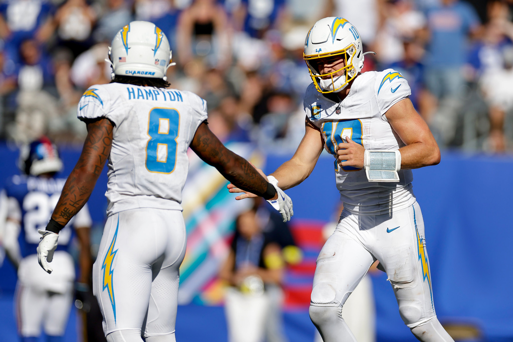 Los Angeles Chargers running back Omarion Hampton (8) is congratulated by quarterback Justin Herbert (10) after scoring a touchdown against the New York Giants during the third quarter of an NFL football game, Sunday, Sept. 28, 2025, in East Rutherford, N.J. (AP Photo/Adam Hunger)