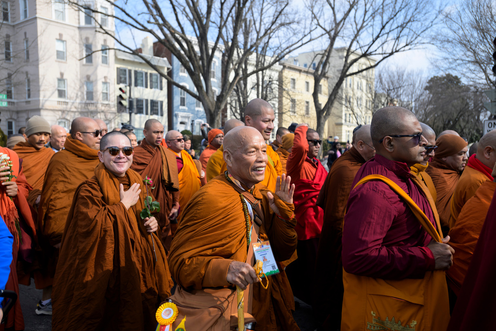 Buddhist monks walk through a neighborhood on Capitol Hill, during the Walk for Peace, in Washington, Wednesday, Feb., 11, 2026. (AP Photo/Rod Lamkey, Jr.)