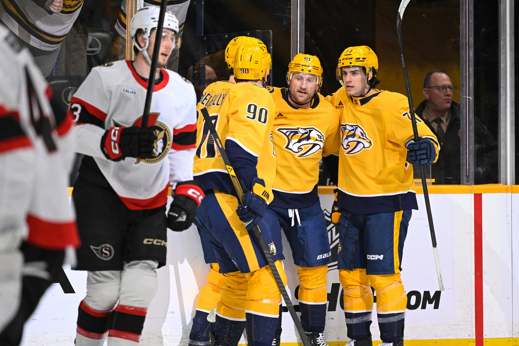 Nashville Predators center Steven Stamkos, second from right, celebrates after his goal with right wing Matthew Wood, right, and center Ryan O'Reilly (90) during the second period of an NHL hockey game against the Ottawa Senators, Thursday, Jan. 22, 2026, in Nashville, Tenn. (AP Photo/John Amis)