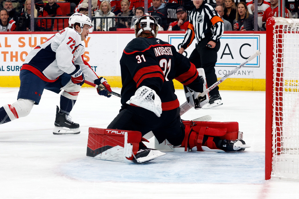 Washington Capitals' Anthony Beauvillier (72) has his shot blocked by Carolina Hurricanes goaltender Frederik Andersen (31) during the first period of an NHL hockey game in Raleigh, N.C., Tuesday, Nov. 11, 2025. (AP Photo/Karl DeBlaker)