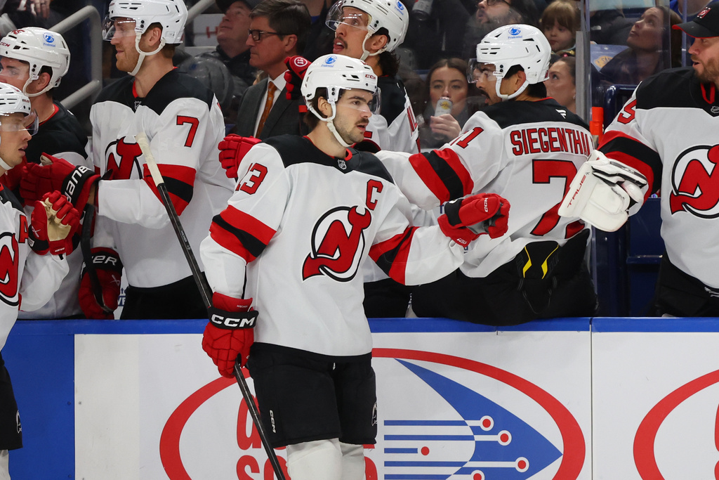 New Jersey Devils center Nico Hischier (13) celebrates after his goal during the first period of an NHL hockey game against the Buffalo Sabres, Friday, Nov. 28, 2025, in Buffalo, N.Y. (AP Photo/Jeffrey T. Barnes)