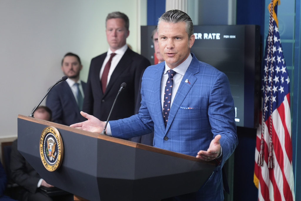 Defense Secretary Pete Hegseth, from right, speaks as Army Secretary Dan Driscoll and White House Deputy Chief of Staff Taylor Budowich listen during a press briefing with President Donald Trump in the James Brady Press Briefing Room at the White House, Monday, Aug. 11, 2025, in Washington. (AP Photo/Mark Schiefelbein)