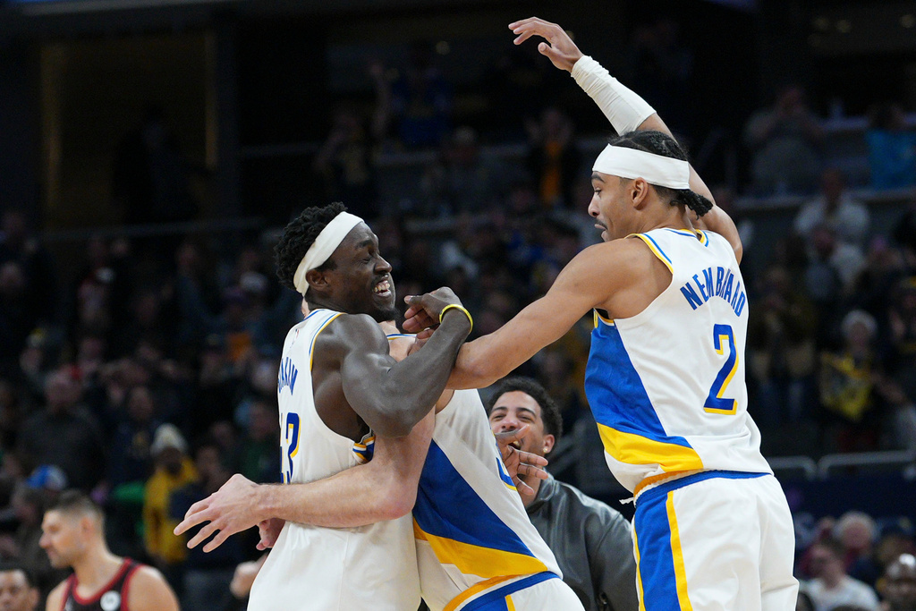 Indiana Pacers forward Pascal Siakam, left, celebrates making the game winning shot with teammate Andrew Nembhard after defeating the Chicago Bulls in an NBA basketball game in Indianapolis, Saturday, Nov. 29, 2025. (AP Photo/AJ Mast)
