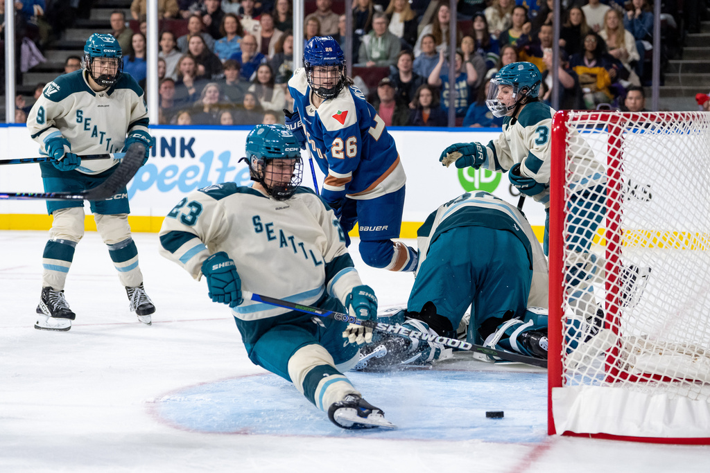 Vancouver Goldeneyes' Claire Thompson (42), not seen, scores on Seattle Torrent goaltender Corinne Schroeder (30) as Megan Carter (23) tries to defend with Jessie Eldridge (9), Cayla Barnes (3), and Goldeneyes' Brooke McQuigge (26) watching during the third period of a PWHL hockey game in Vancouver, on Friday, Nov. 21, 2025. (Ethan Cairns/The Canadian Press via AP)