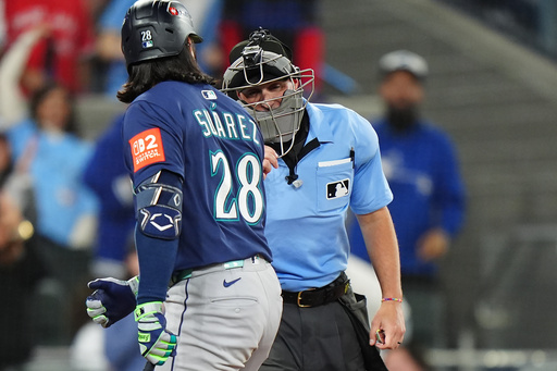 Seattle Mariners' Eugenio Suárez (28) argues with home plate umpire Quinn Wolcott, right, during the eighth inning in Game 7 of baseball's American League Championship Series against the Toronto Blue Jays in Toronto, Monday, Oct. 20, 2025. (Frank Gunn/The Canadian Press via AP) Seattle Mariners' Eugenio Suárez (28) argues with home plate umpire Quinn Wolcott, right, during the eighth inning in Game 7 of baseball's American League Championship Series against the Toronto Blue Jays in Toronto, Monday, Oct. 20, 2025. (Frank Gunn/The Canadian Press via AP)