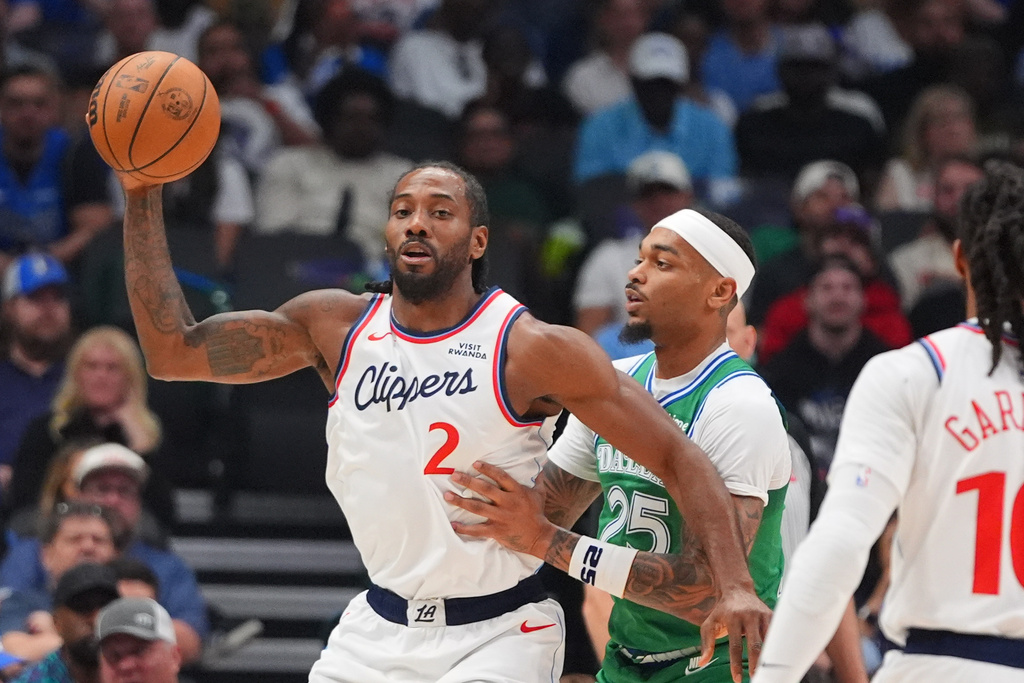 Los Angeles Clippers forward Kawhi Leonard (2) handles the ball against Dallas Mavericks forward P.J. Washington (25) during the first half of an NBA basketball game in Dallas, Saturday, March 21, 2026. (AP Photo/LM Otero)