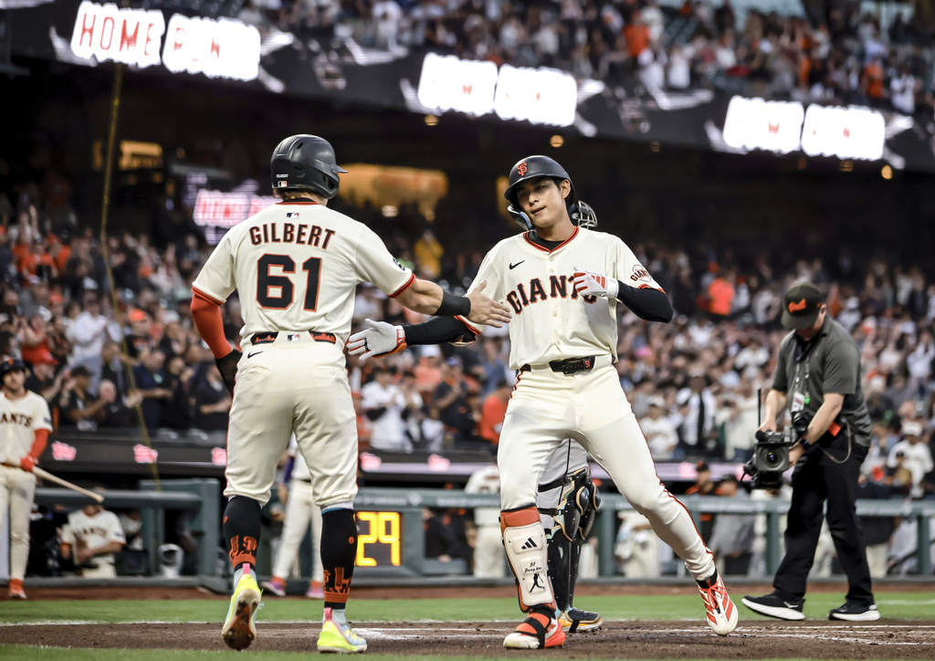 San Francisco Giants' Jung Hoo Lee, right, celebrates with teammate Andrew Gilbert (61) after they scored on Lee's two-run home run in the second inning of a baseball game against the Arizona Diamondbacks in San Francisco, Monday, Sept. 8, 2025. (Carlos Avila Gonzalez/San Francisco Chronicle via AP)