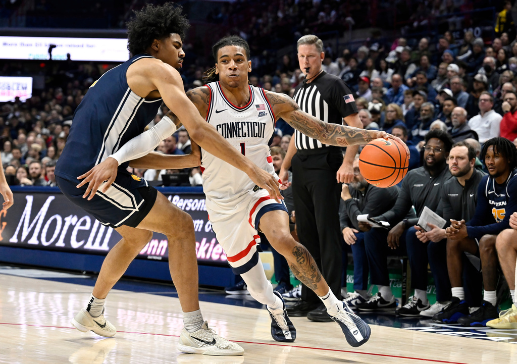 UConn guard Solo Ball (1) is guarded by East Texas A&M's Michael Folarin, left, in the first half of an NCAA college basketball game, Friday, Dec. 5, 2025, in Storrs, Conn. (AP Photo/Jessica Hill)