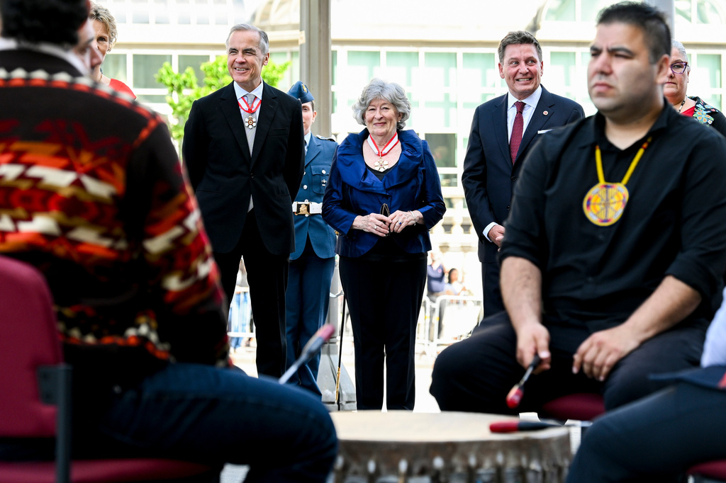 Designate Gov. Gen. Louise Arbour, centre, and Canadian Prime Minister Mark Carney look on ahead of a drum circle during her installation ceremony at the Senate of Canada in Ottawa, on Monday, June 8, 2026. (Spencer Colby/The Canadian Press via AP)