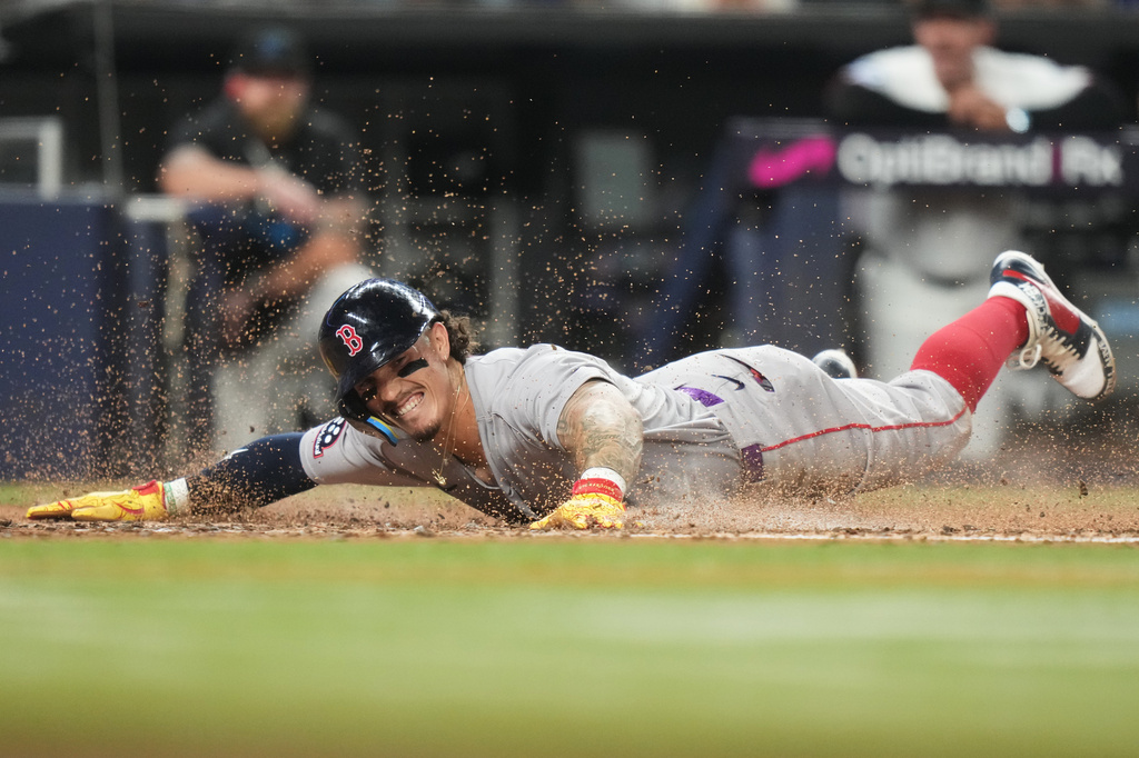 Boston Red Sox's Jarren Duran scores on a double hit by Mickey Gasper during the fifth inning of a baseball game against the Miami Marlins, Monday, Aug. 24, 2026, in Miami. (AP Photo/Lynne Sladky)