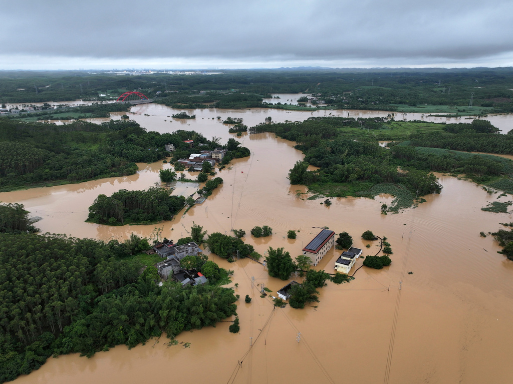In this photo released by Xinhua News Agency, an aerial view shows flooded areas of after tropical storm Maysak past Liujia Village in Qinzhou, south China's Guangxi Zhuang Autonomous Region, July 7, 2026.(Ao Shuaichang/Xinhua via AP)