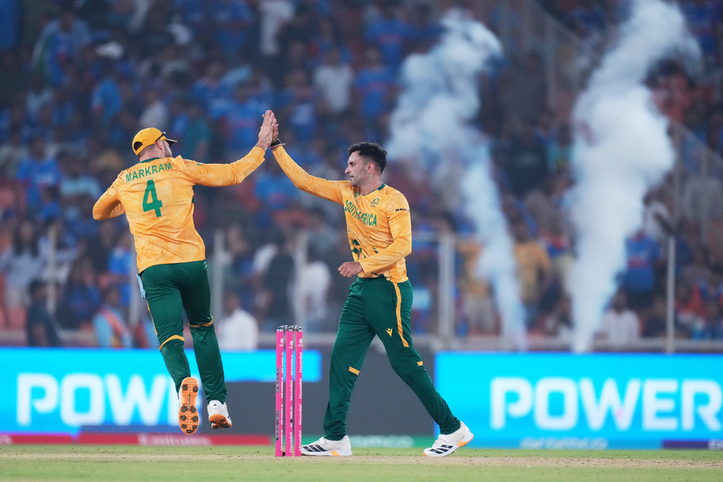South Africa's Keshav Maharaj, right, celebrates with captain Aiden Markram the wicket of India's Arshdeep Singh during the T20 World Cup cricket match between India and South Africa in Ahmedabad, India, Sunday, Feb. 22, 2026. (AP Photo/Ajit Solanki)