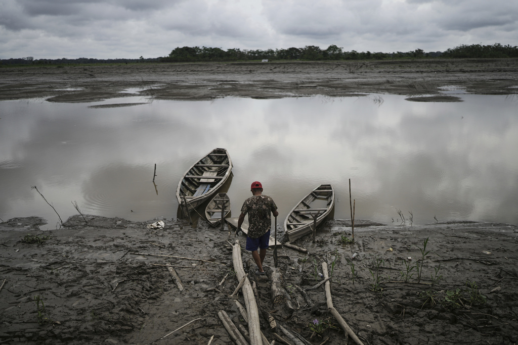 A fisherman walks to his boat in Santa Rosa, Peru, an island on the Amazon River at the center of a territorial dispute with Colombia, Sunday, Aug. 17, 2025. (AP Photo/Ivan Valencia)