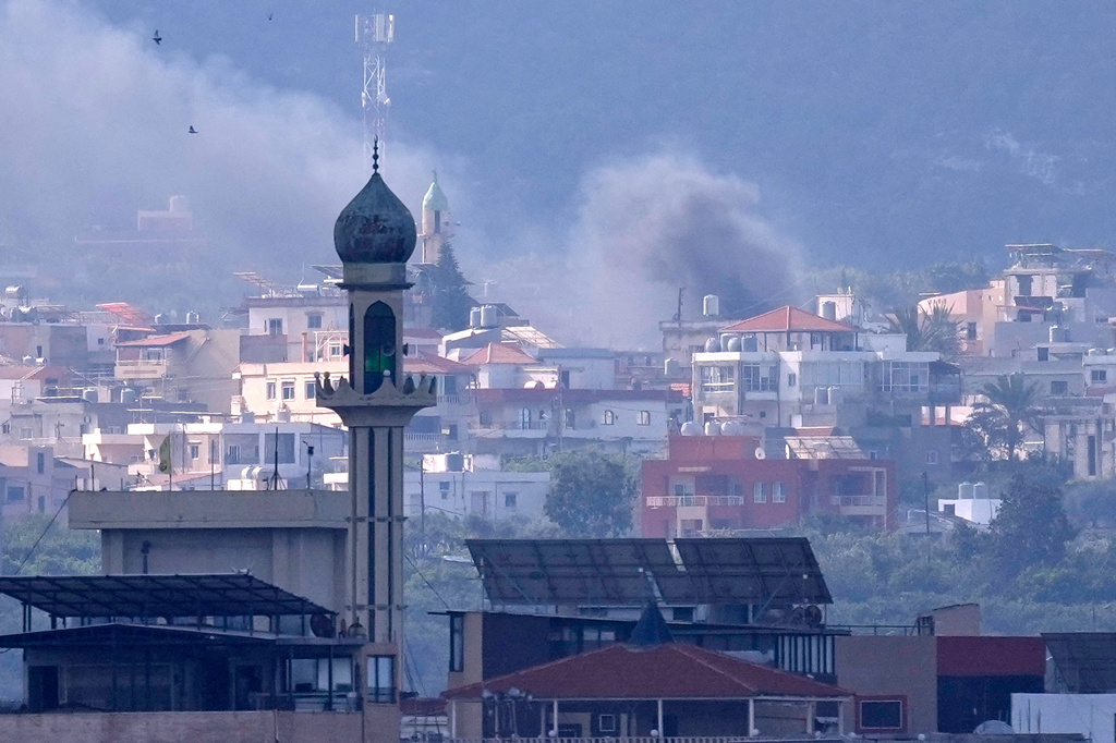 Some rising from an Israeli airstrike that hit Qlaileh village, is seen from Tyre city, south Lebanon, Friday, March 27, 2026. (AP Photo/Hussein Malla)