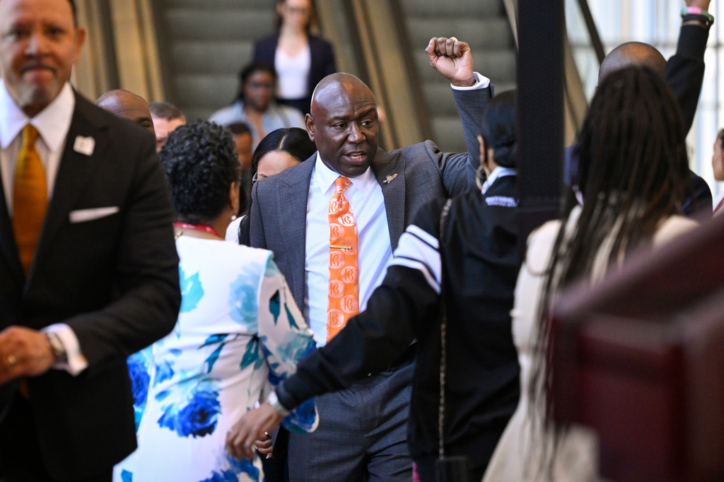 Attorney Ben Crump raises his fist as he arrives with clients Christine Wonsley and Elmore Wonsley, mother and step father of Nolan Wells who was found dead after taking a July 4 boat trip with friends, as they appear at the National Urban League's annual conference, Thursday, July 30, 2026, in Nashville, Tenn. (AP Photo/John Amis)