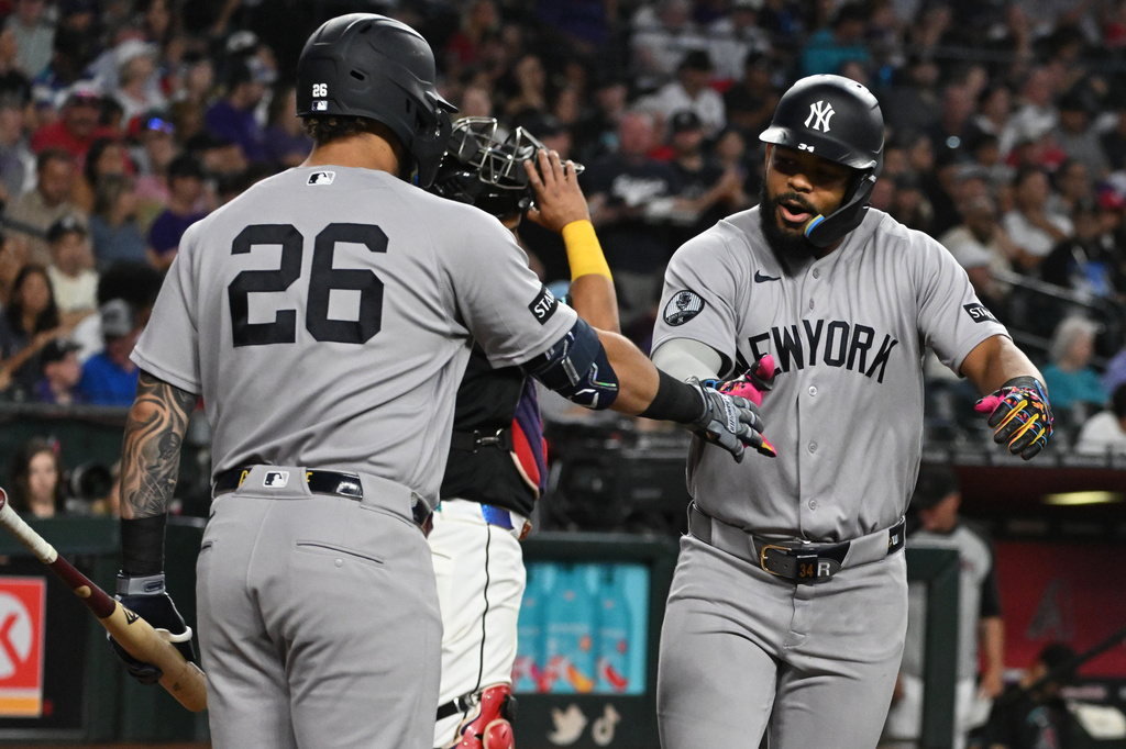 New York Yankees' Heliot Ramos, right, celebrates with Luis García Jr. (26) after Ramos' home run during the third inning of a baseball game against the Arizona Diamondbacks, Sunday, Sept. 20, 2026, in Phoenix. (AP Photo/Caitlin O'Hara)