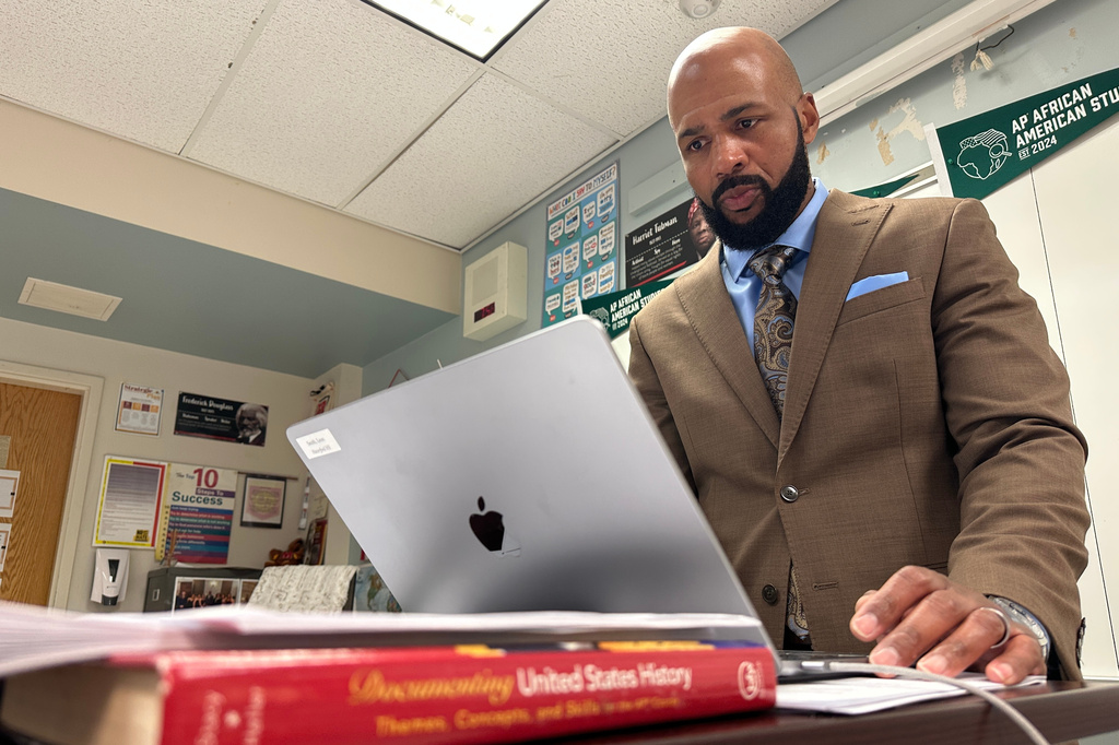 Leon Smith, named the 2026 National Teacher of the Year, stands in front of his classroom at Haverford High School, in Havertown, Pa. on Monday, April 20, 2026. (AP Photo/Tassanee Vejpongsa)
