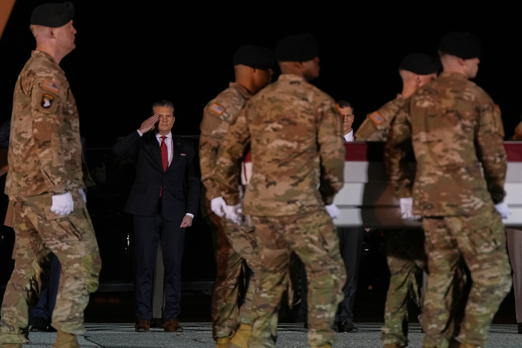Defense Secretary Pete Hegseth salutes as an U.S. Army carry team moves the transfer case containing the remains of Sgt. Benjamin N. Pennington, 26, of Glendale, Ky., Monday March 9, 2026, at Dover Air Force Base, Del. (AP Photo/Julia Demaree Nikhinson)