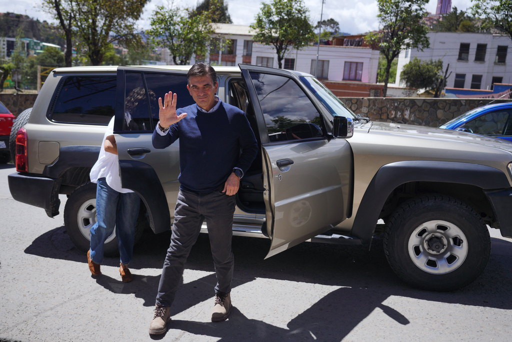 Presidential candidate Rodrigo Paz arrives to accompany his daughter Catalina to vote in a presidential runoff election in La Paz, Bolivia, Sunday, Oct. 19, 2025. (AP Photo/Ivan Valencia)